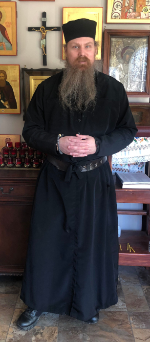 A full-length portrait of Br. CJS Hayward.