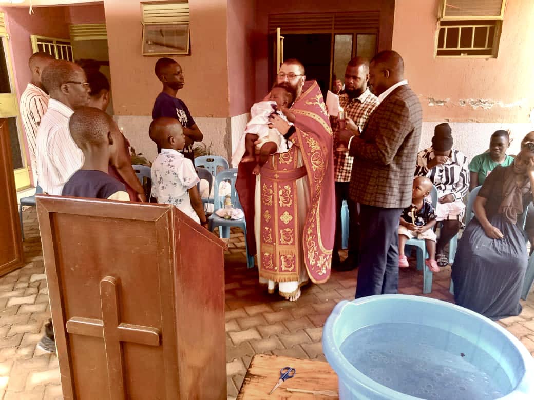 Fr. Silouan Brown serving the Lord in Uganda, standing with others at his mission.